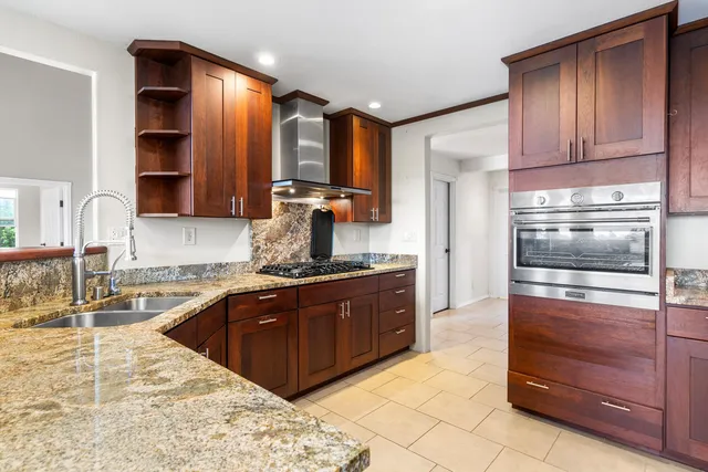 a kitchen with stainless steel appliances granite countertop a sink and cabinets