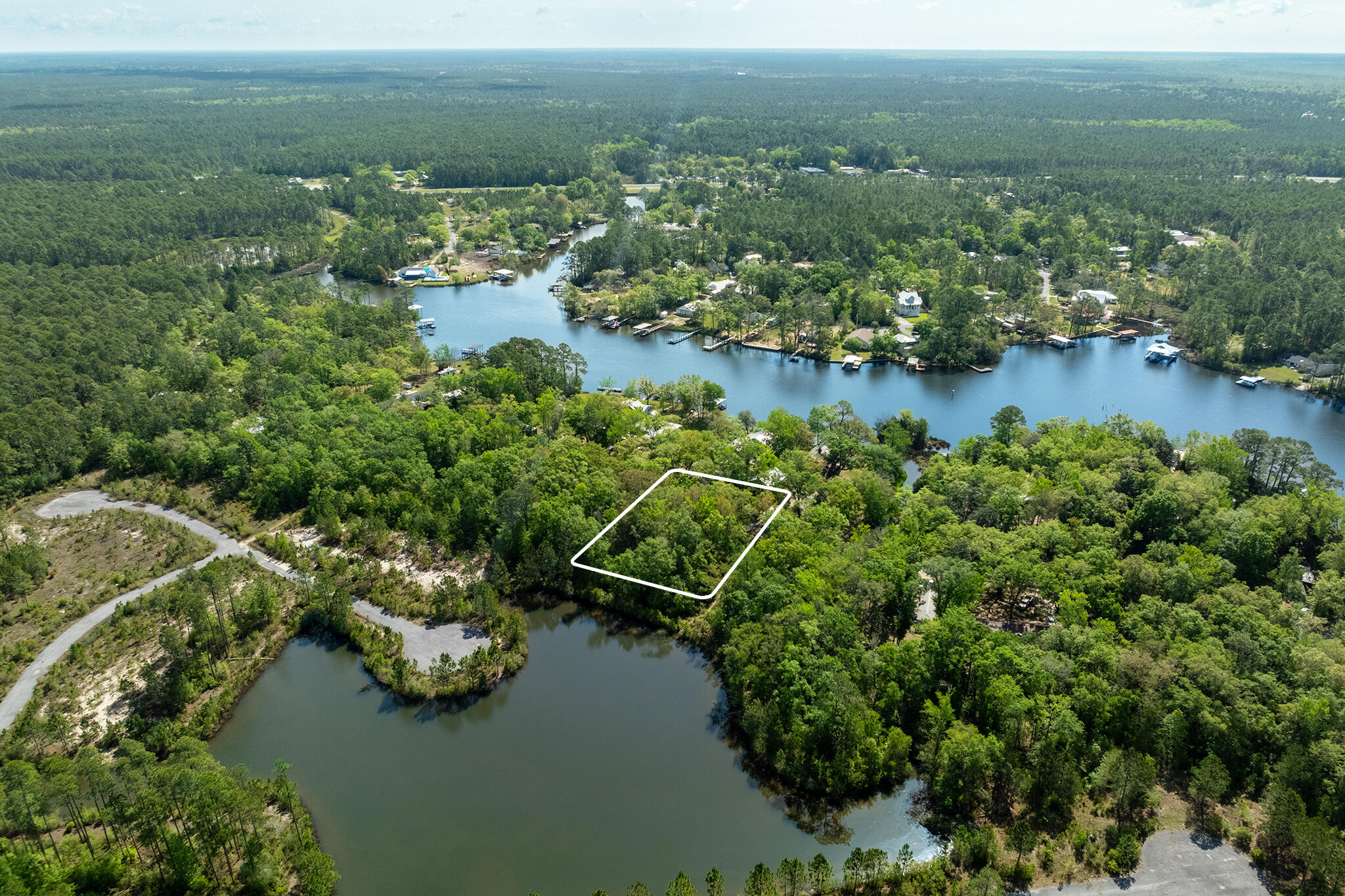 an aerial view of a houses with outdoor space and lake view