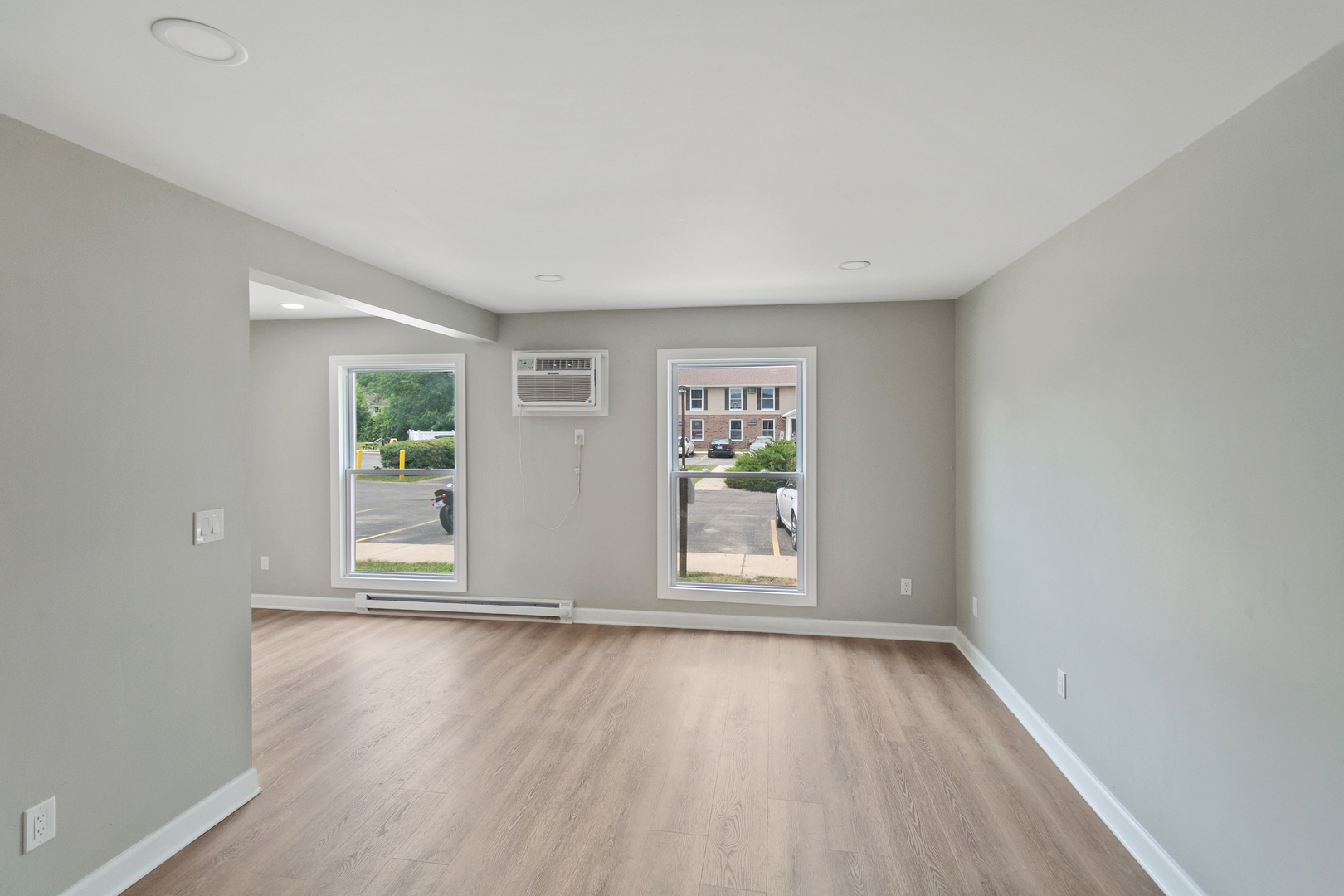 405 East Reed Street, Unit 9 Braidwood, IL 60408 - Photo 11 of 14 an empty room with wooden floor and windows