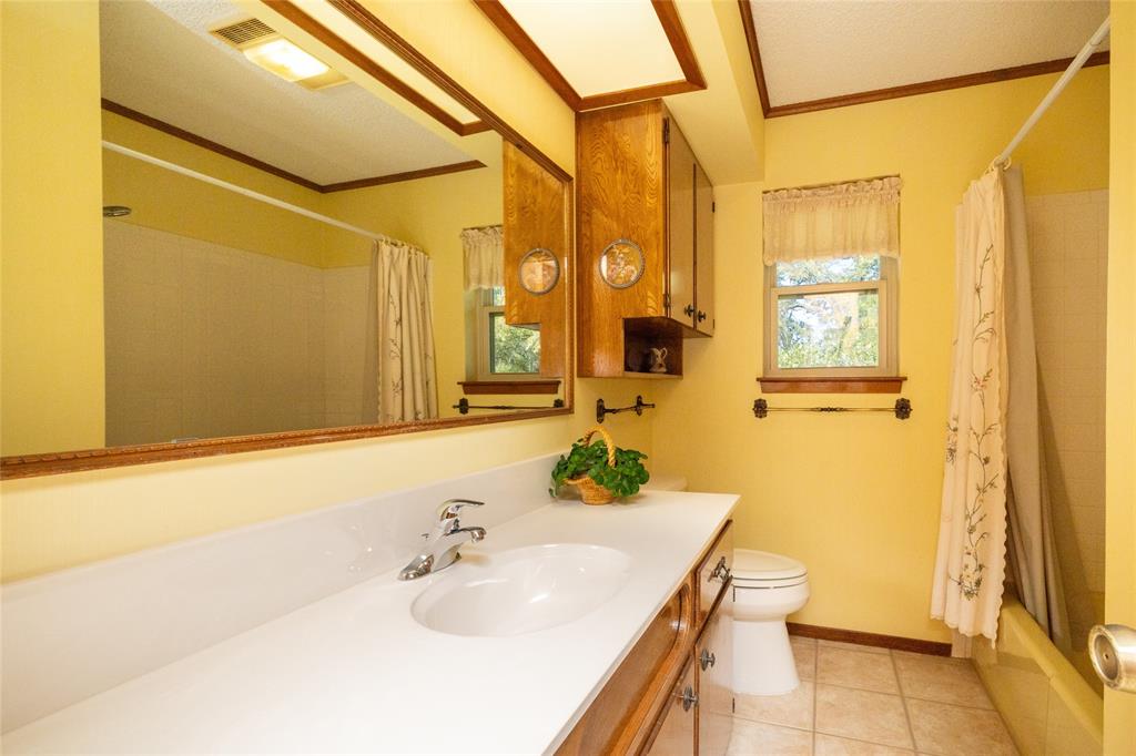 970 Live Oak Road Santo, TX 76472 - Photo 29 of 40 a bathroom with a sink and a mirror