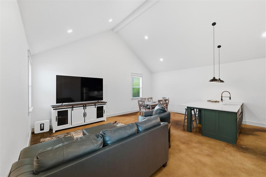 6625 Sandy Beach Road Azle, TX 76020 - Photo 33 of 40 Guest house features vaulted ceilings, recessed lighting, open-concept living and dining area, spacious kitchen island with seating, large windows for natural light, and polished concrete flooring throughout.
