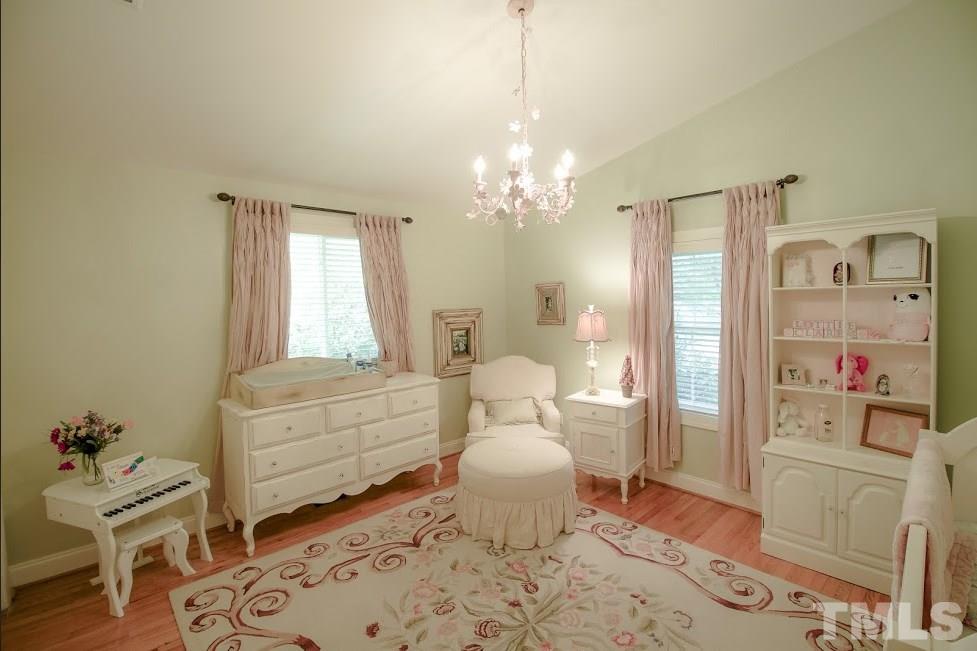 1205 Gunnison Place Raleigh, NC 27609 - Photo 12 of 14 a living room with furniture and a chandelier