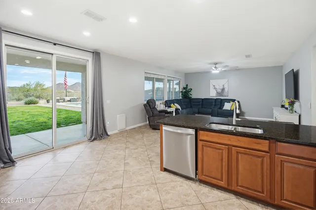 a bedroom with a bed and a window with a bookshelf