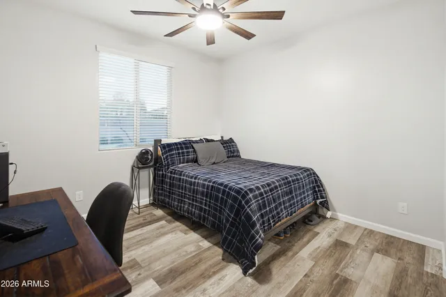 a bathroom with a granite countertop sink a toilet and a mirror
