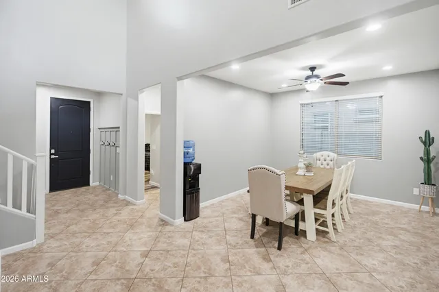 a kitchen with kitchen island granite countertop wooden cabinets a dining table and chairs