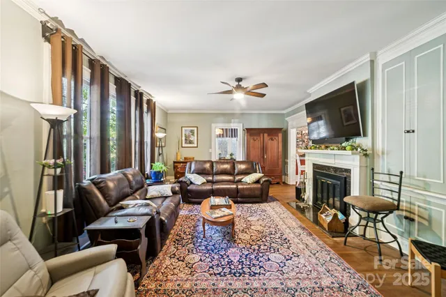 a living room with furniture a fireplace and a flat screen tv