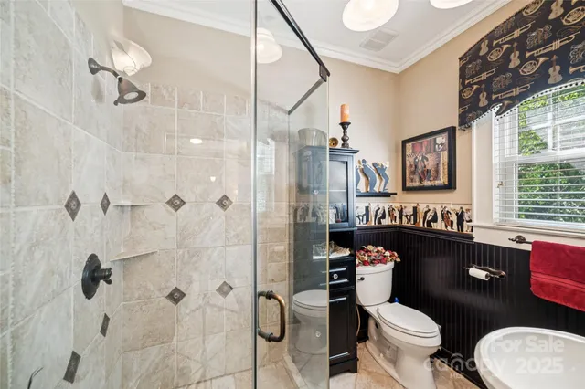 a bathroom with a granite countertop toilet sink shower and mirror
