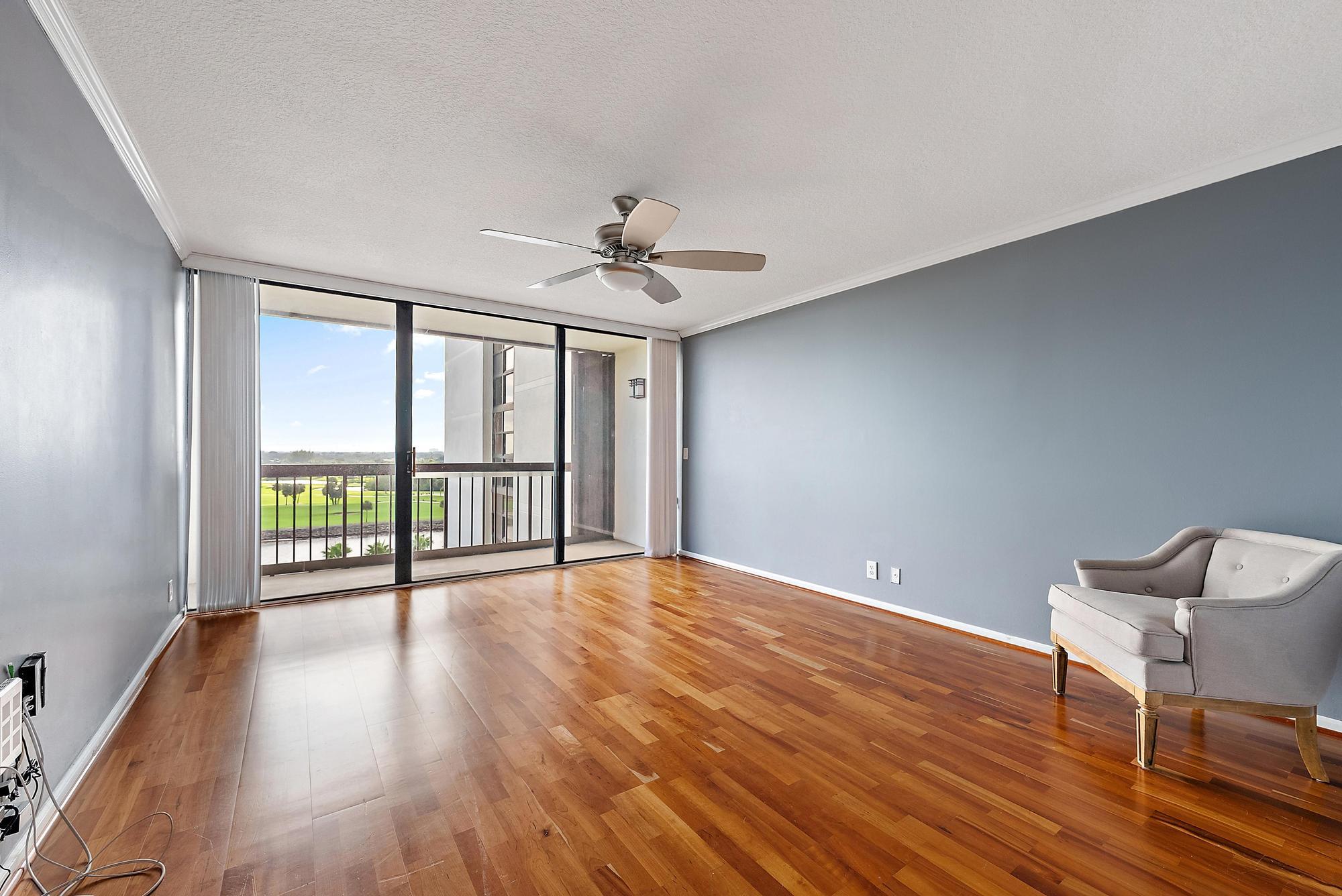 356 Golfview Road, Unit 805 North Palm Beach, FL 33408 - Photo 12 of 29 a view of an empty room with a window and wooden floor