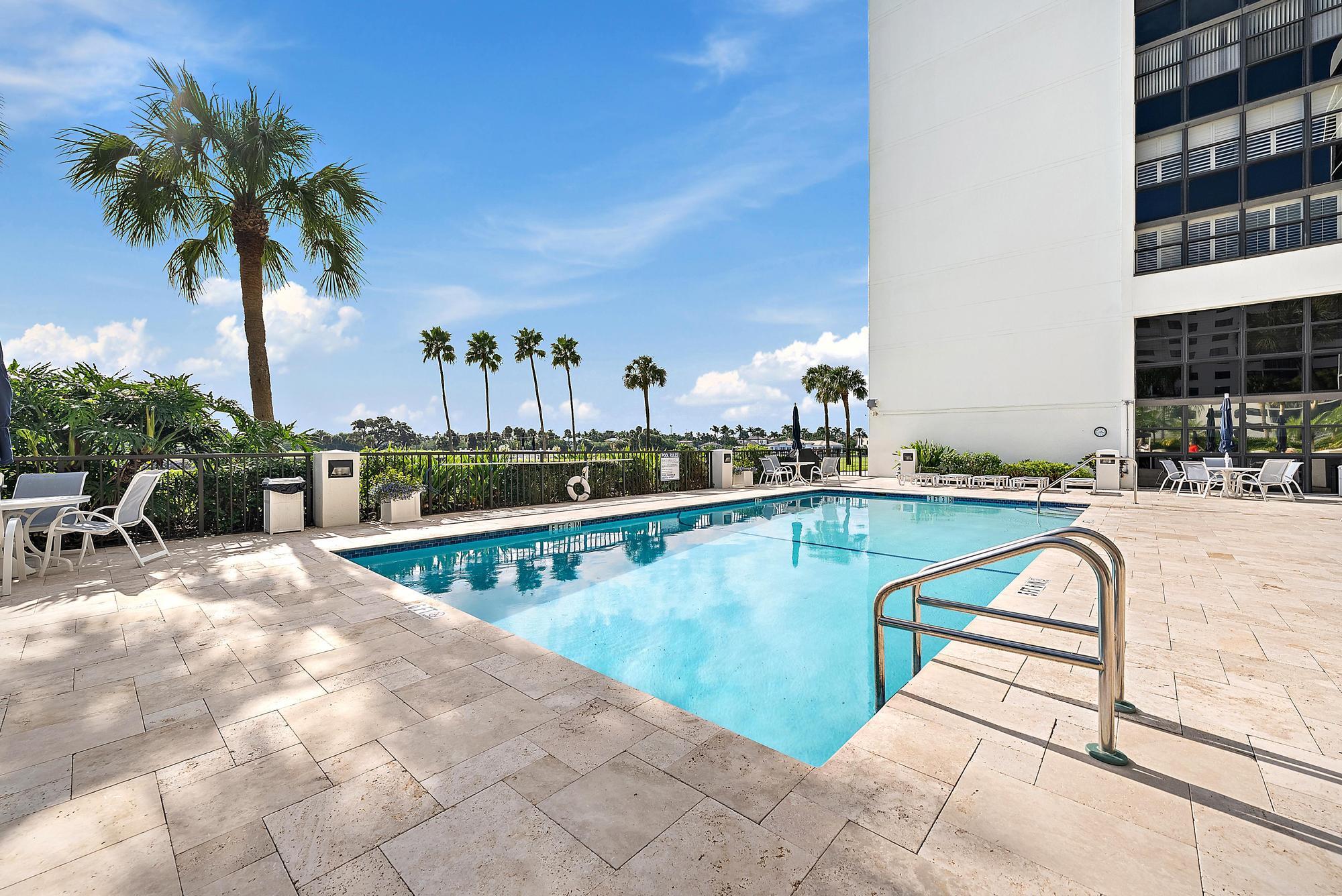 356 Golfview Road, Unit 805 North Palm Beach, FL 33408 - Photo 25 of 29 a view of swimming pool with outdoor seating and potted plants