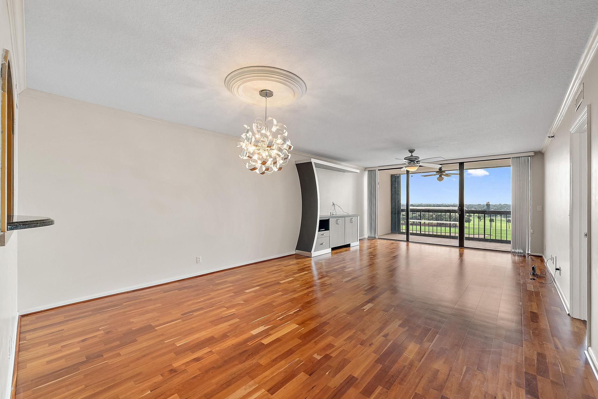 356 Golfview Road, Unit 805 North Palm Beach, FL 33408 - Photo 3 of 29 a view of an empty room with wooden floor and a window