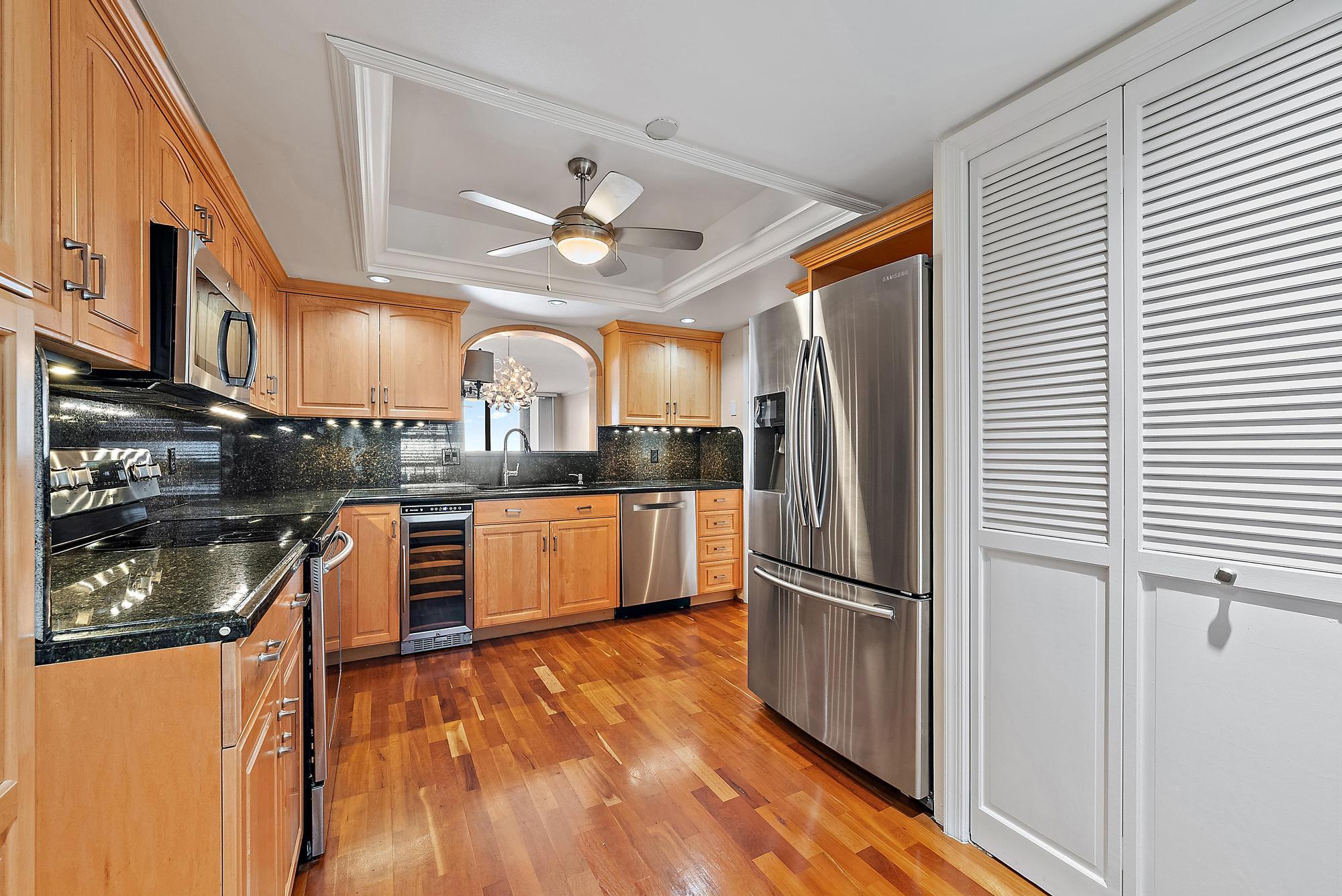 356 Golfview Road, Unit 805 North Palm Beach, FL 33408 - Photo 4 of 29 a kitchen with stainless steel appliances granite countertop a refrigerator a stove and a wooden floors