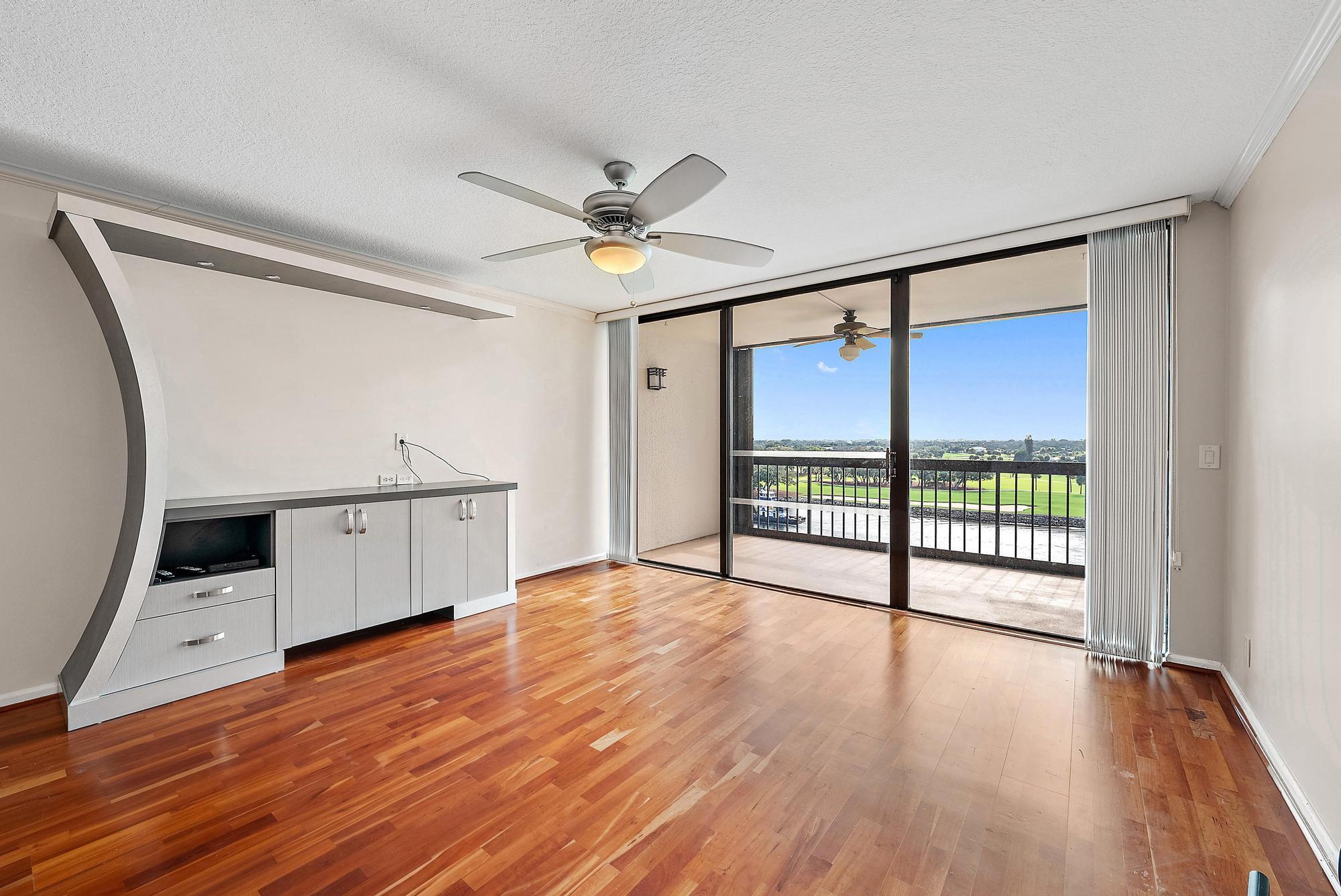 356 Golfview Road, Unit 805 North Palm Beach, FL 33408 - Photo 8 of 29 a view of an empty room with wooden floor and a window