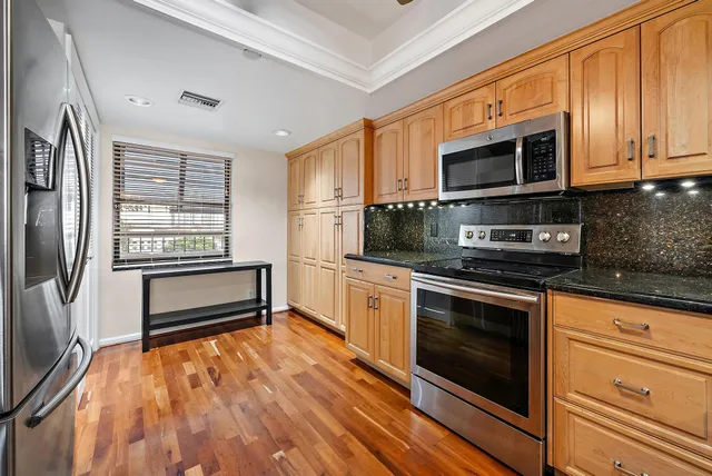 a kitchen with stainless steel appliances a stove sink and microwave