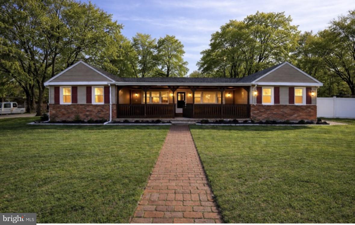 Charming brick home with inviting porch.