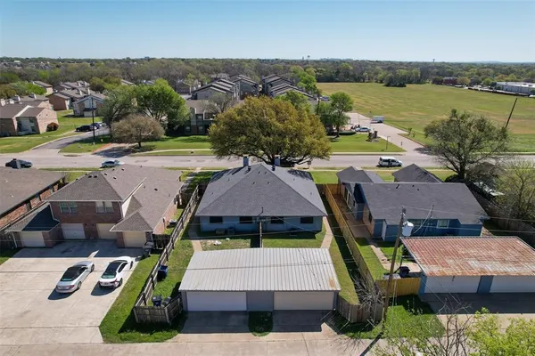 an aerial view of a house with garden space and outdoor seating
