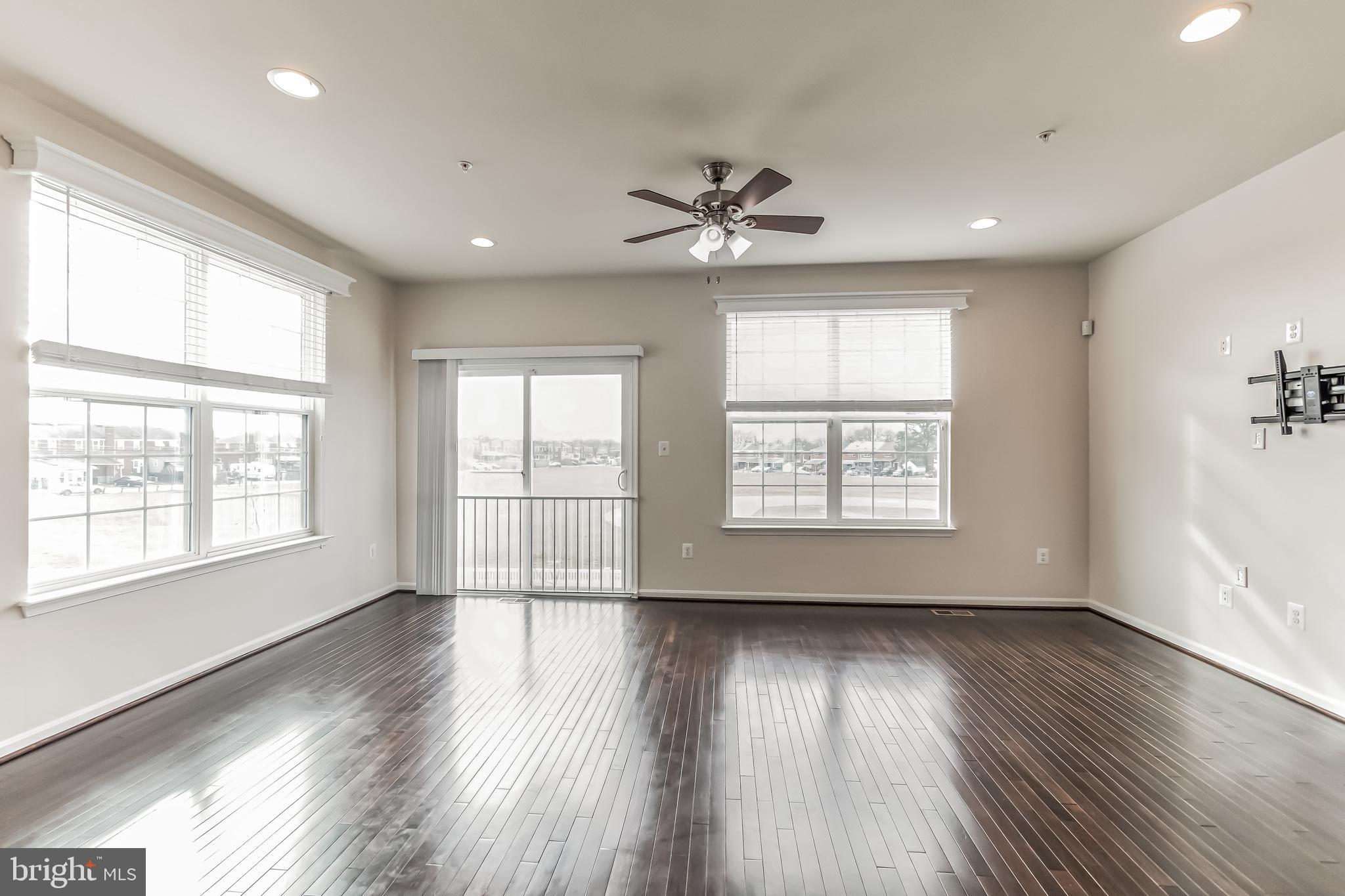 7652 Town View Drive Dundalk, MD 21222 - Photo 12 of 33 a view of an empty room with wooden floor and a window