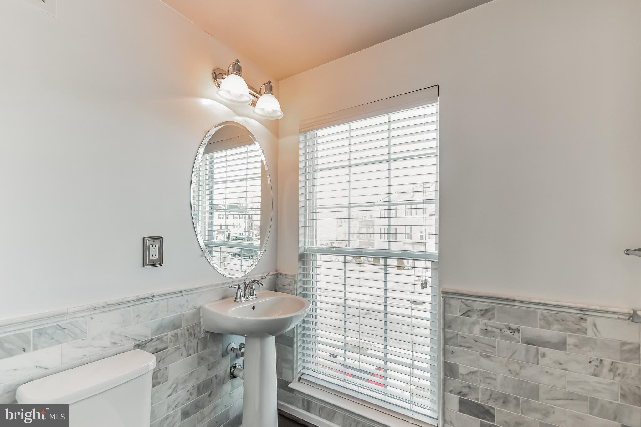 7652 Town View Drive Dundalk, MD 21222 - Photo 13 of 33 a bathroom with a sink and a window