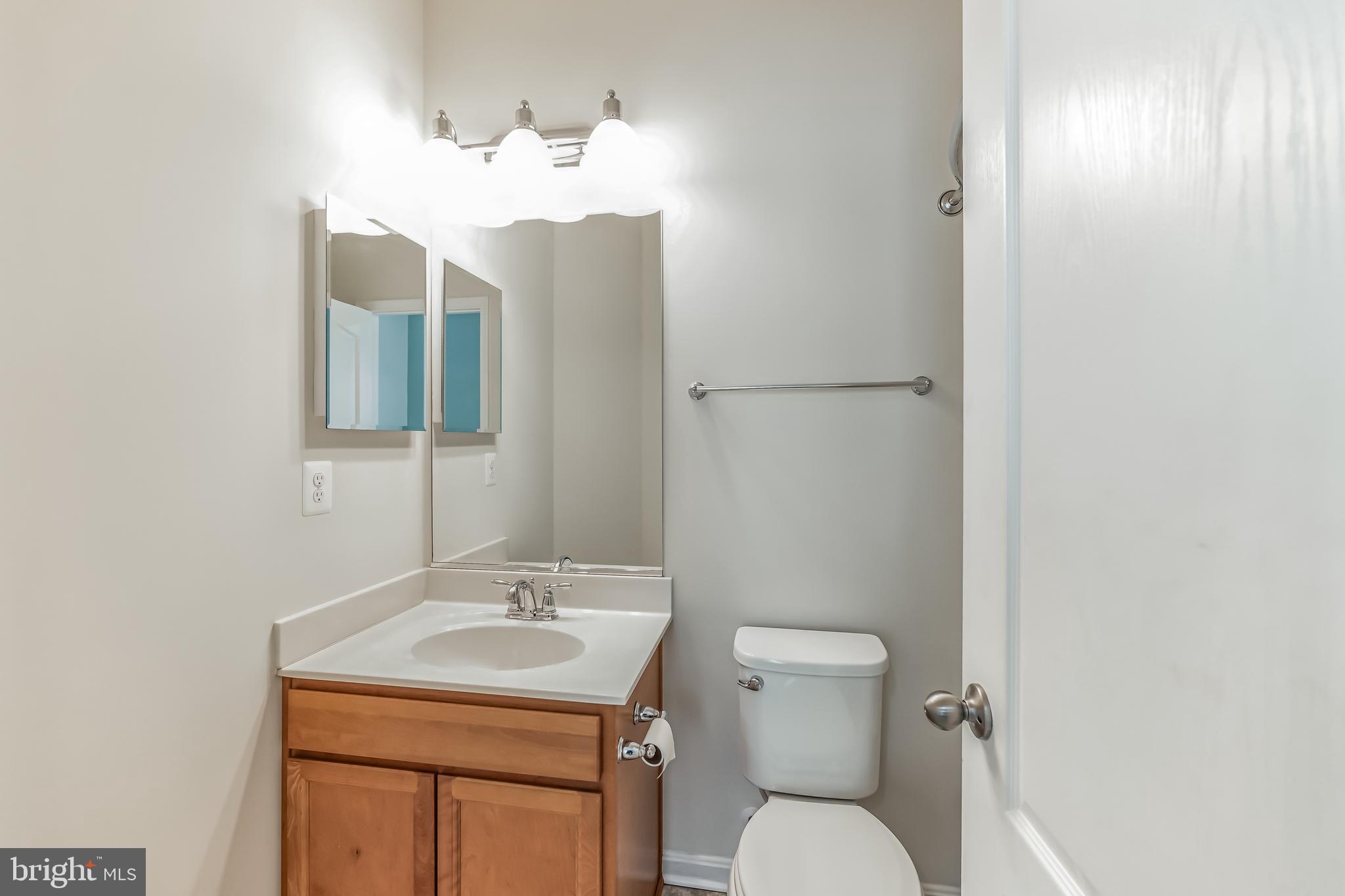 7652 Town View Drive Dundalk, MD 21222 - Photo 24 of 33 a bathroom with a toilet sink and mirror