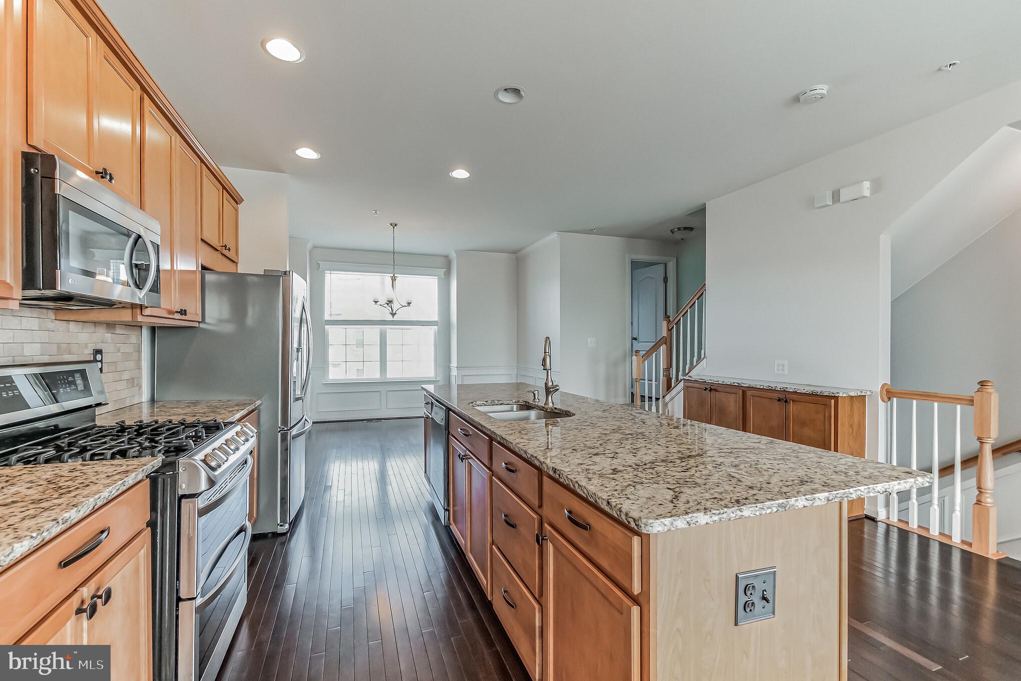 7652 Town View Drive Dundalk, MD 21222 - Photo 5 of 33 a kitchen with stainless steel appliances granite countertop a sink stove and refrigerator