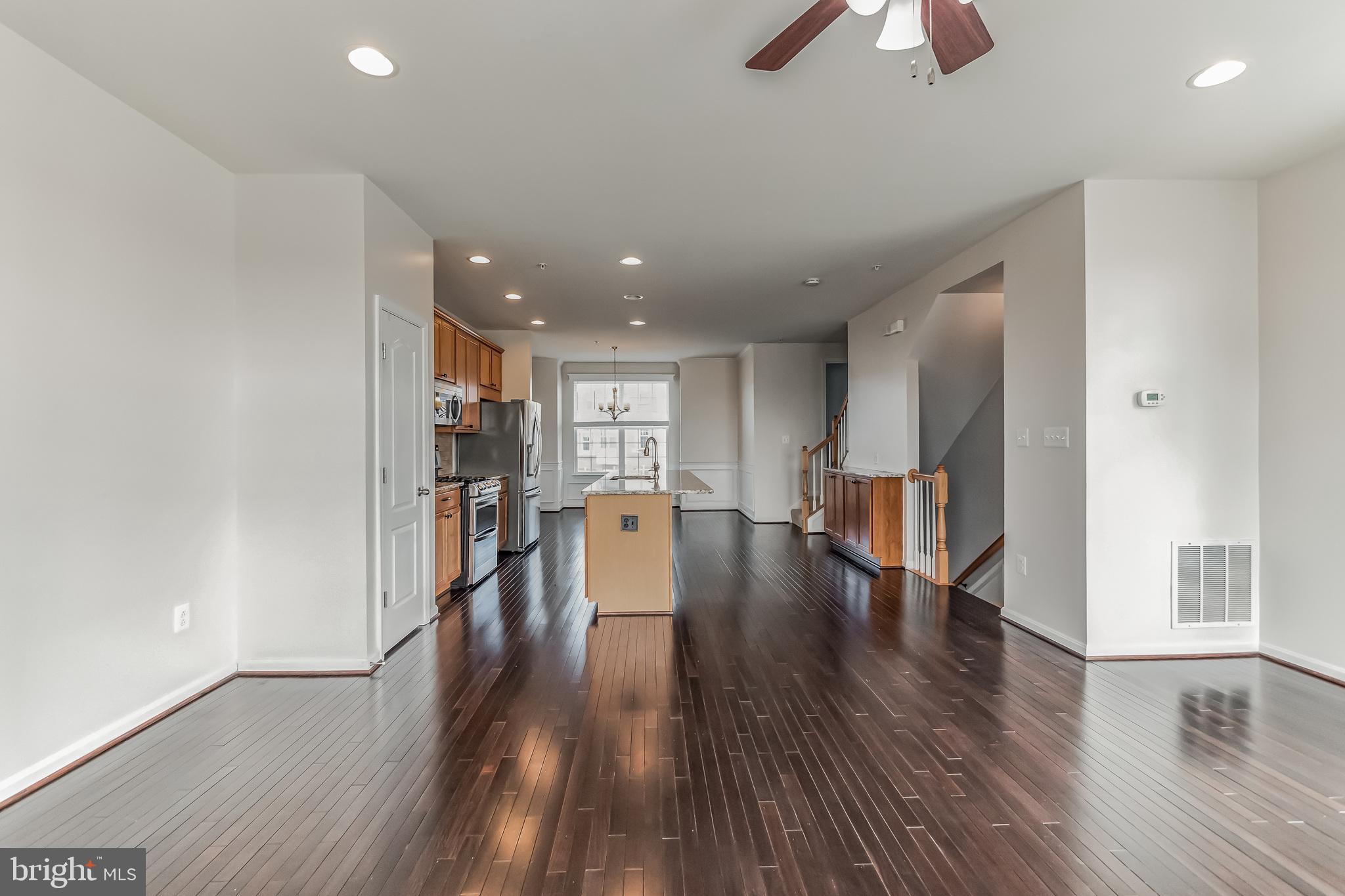 7652 Town View Drive Dundalk, MD 21222 - Photo 6 of 33 a view of a big room with wooden floor and windows
