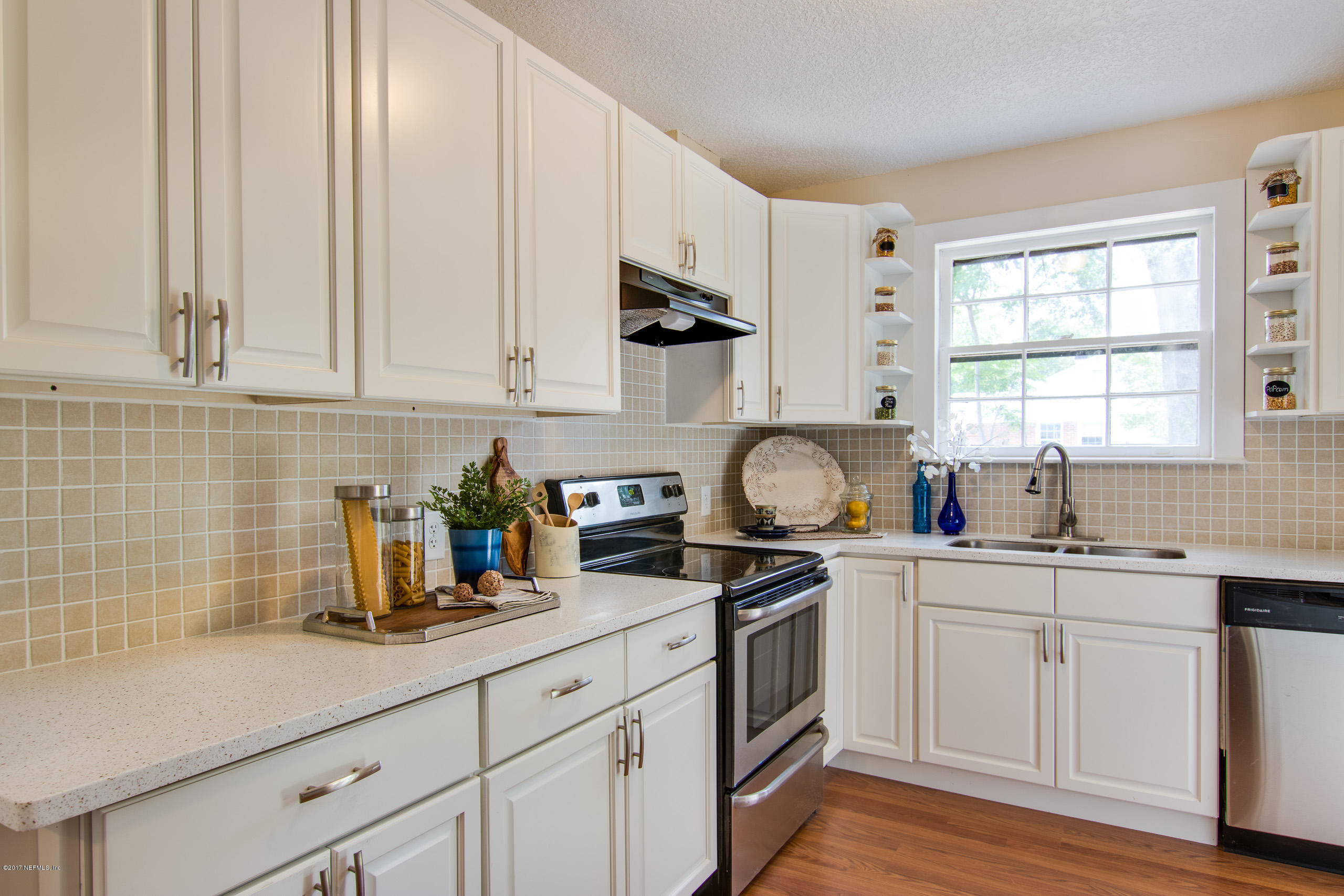 4066 Dover Road Jacksonville, FL 32207 - Photo 7 of 21 a kitchen with stainless steel appliances granite countertop white cabinets a sink and dishwasher next to a window
