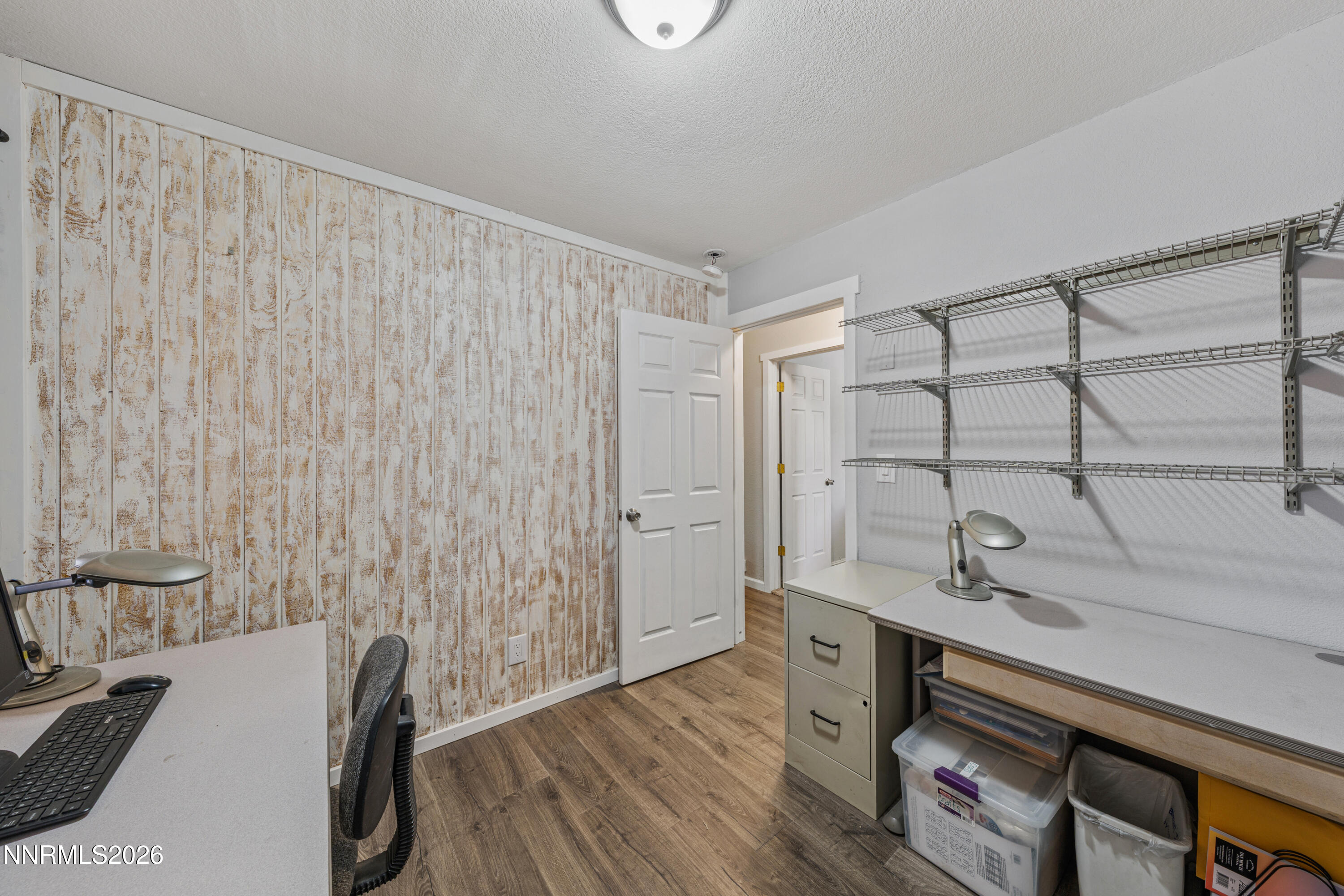 6370 Mono Court Sun Valley, NV 89433 - Photo 12 of 22 a view of a bedroom with wooden floor and furniture