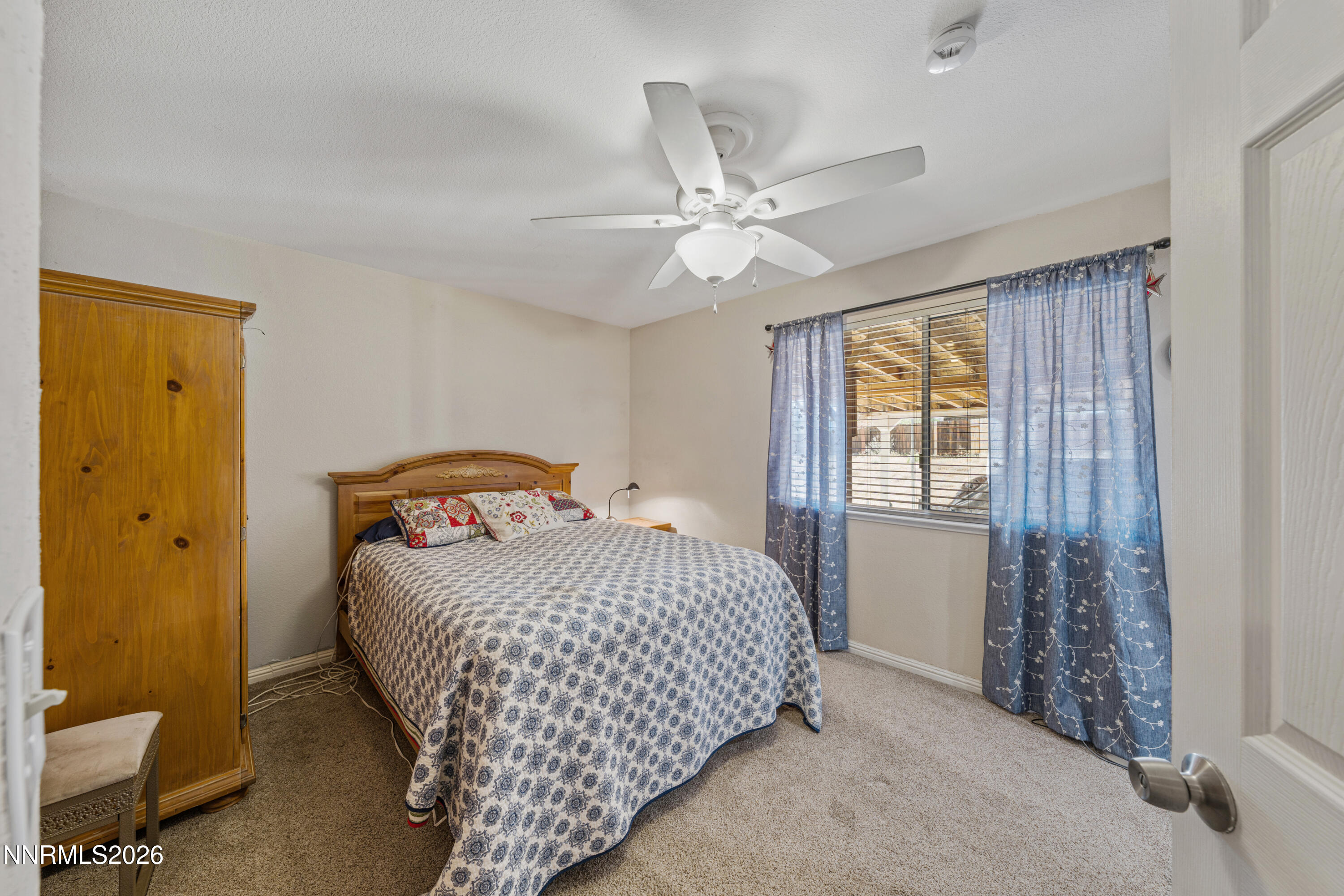 6370 Mono Court Sun Valley, NV 89433 - Photo 13 of 22 a bedroom with a bed and a window