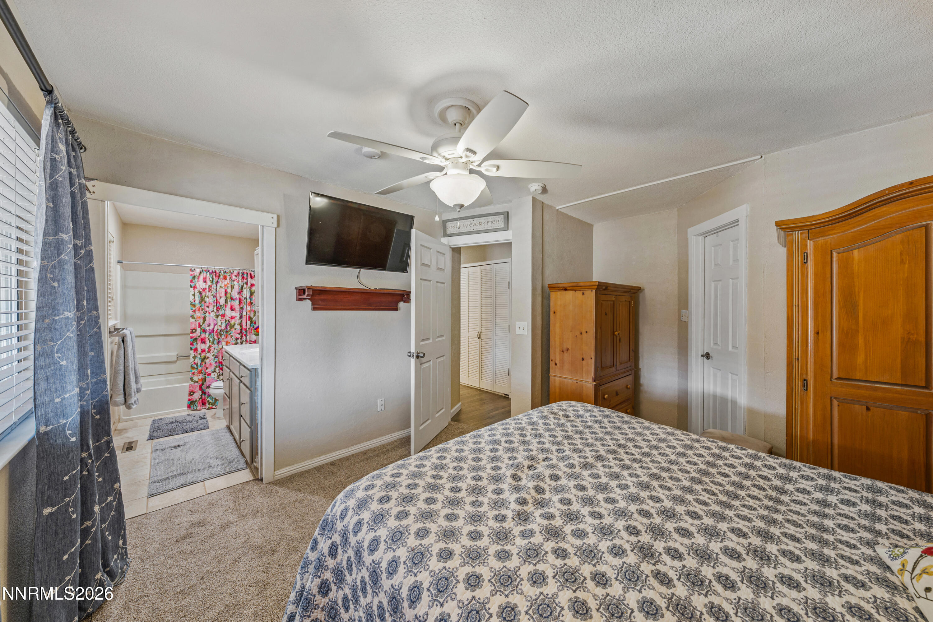 6370 Mono Court Sun Valley, NV 89433 - Photo 14 of 22 a bedroom with a bed and a flat tv screen
