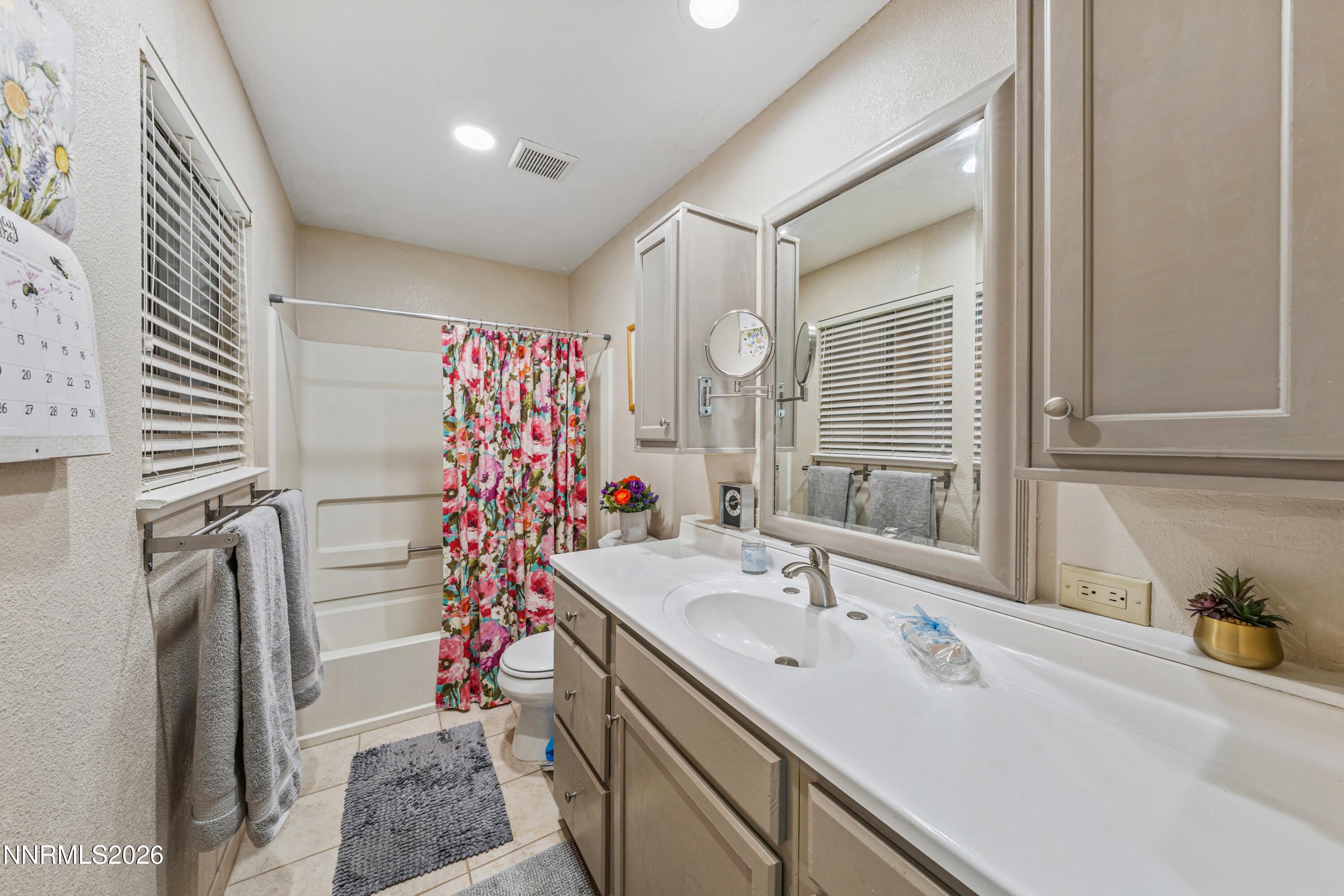 6370 Mono Court Sun Valley, NV 89433 - Photo 15 of 22 a bathroom with a sink and mirror with bathtub