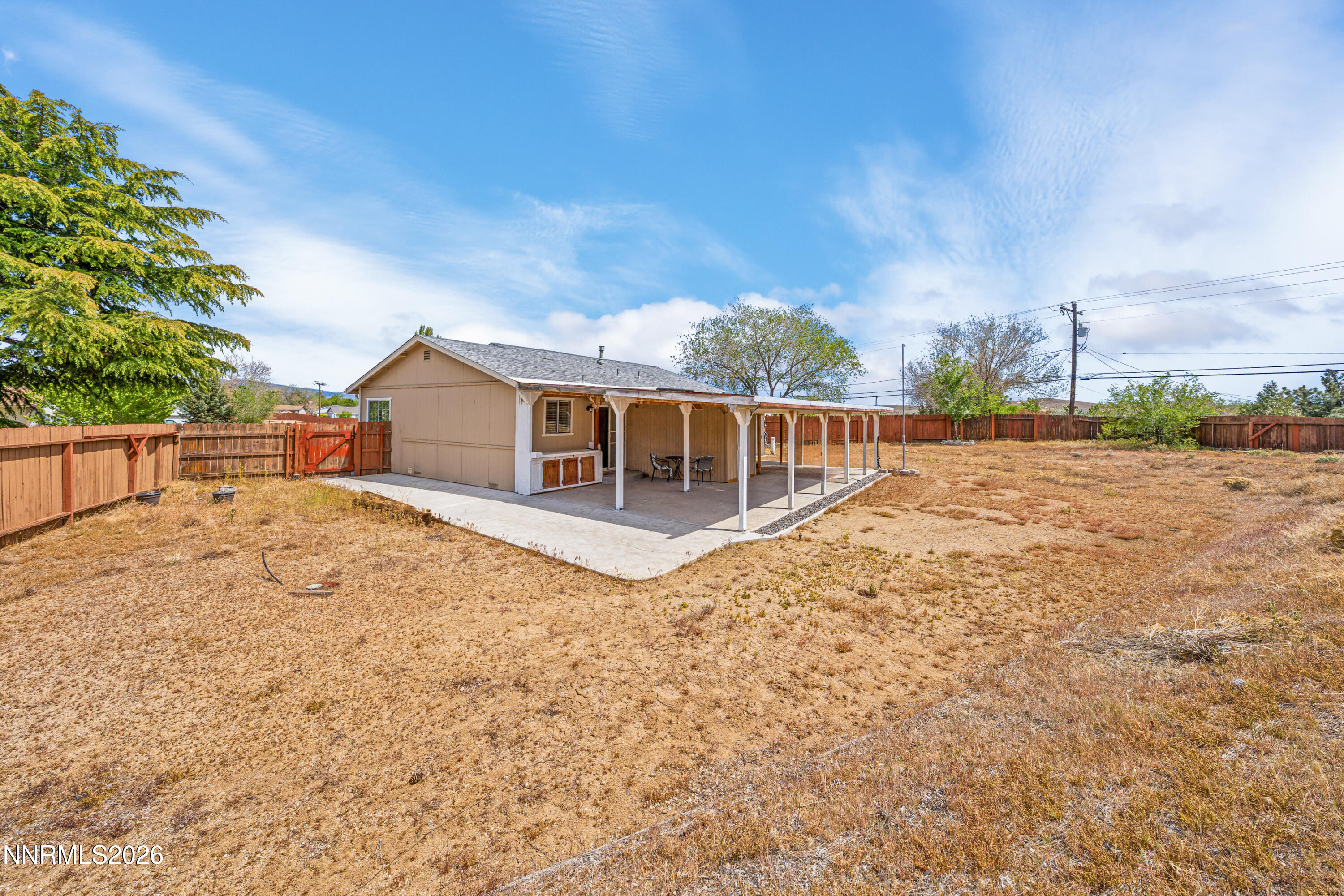 6370 Mono Court Sun Valley, NV 89433 - Photo 16 of 22 a view of house with backyard and trees in the background