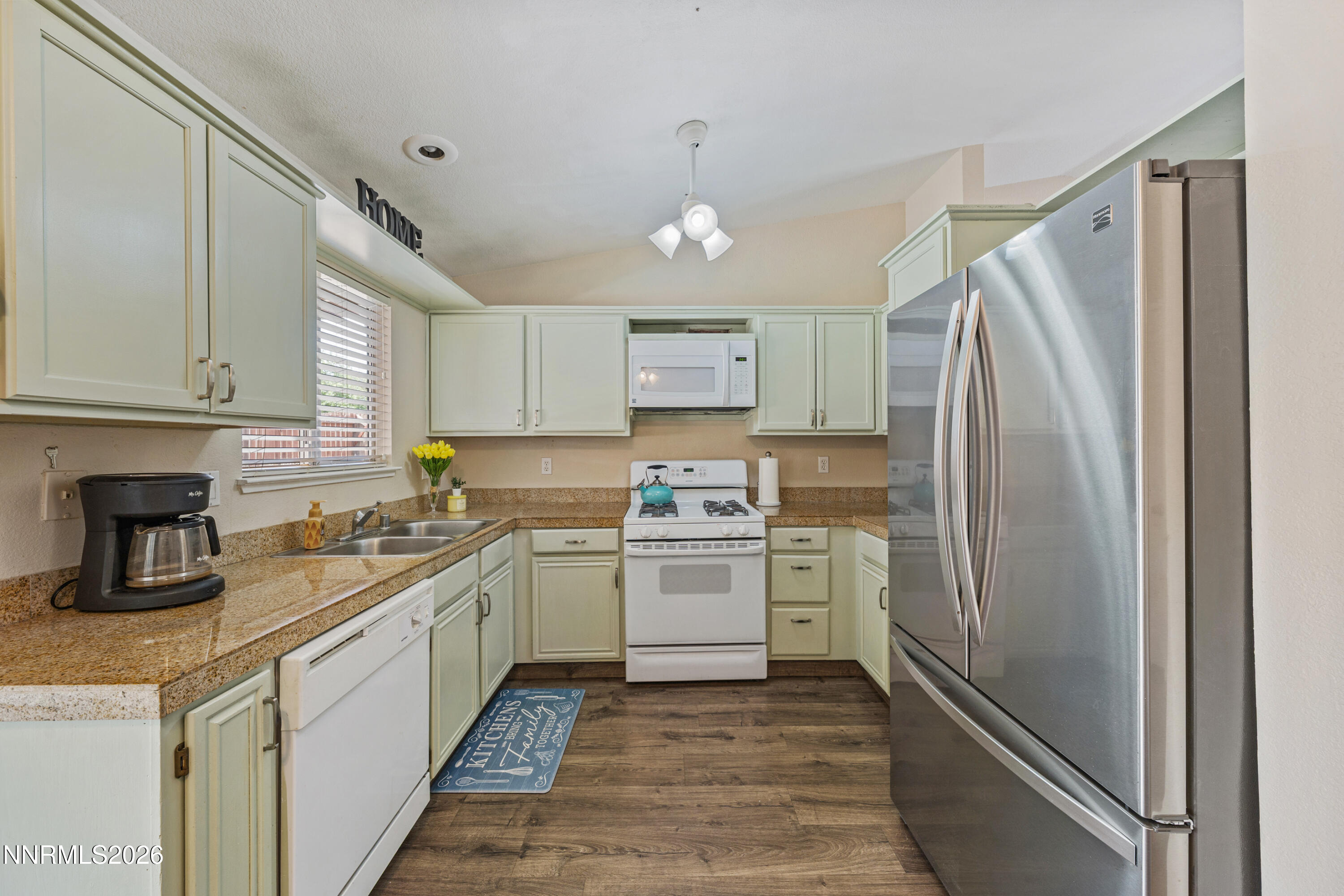 6370 Mono Court Sun Valley, NV 89433 - Photo 5 of 22 a kitchen with a refrigerator sink and cabinets