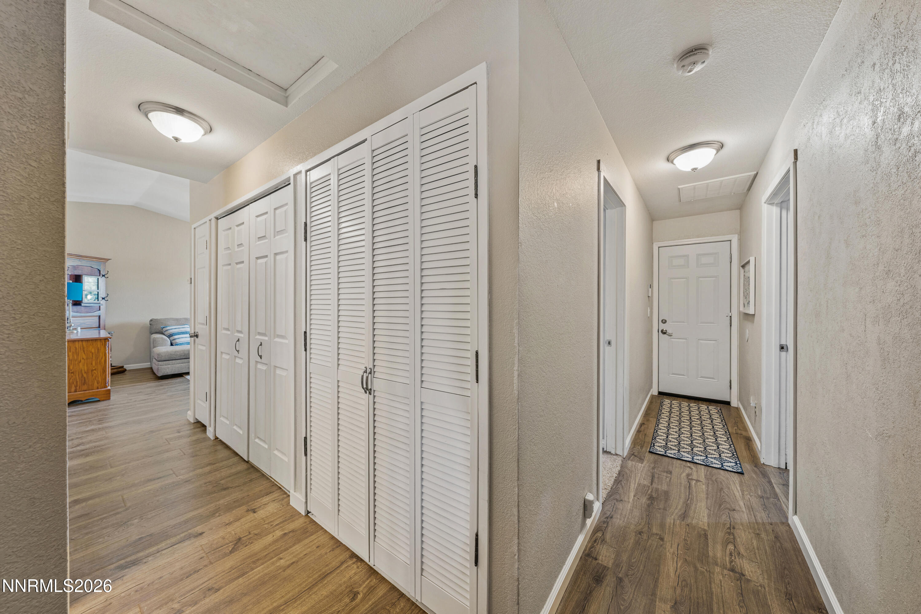 6370 Mono Court Sun Valley, NV 89433 - Photo 7 of 22 a view of a hallway with wooden floor and a bathroom