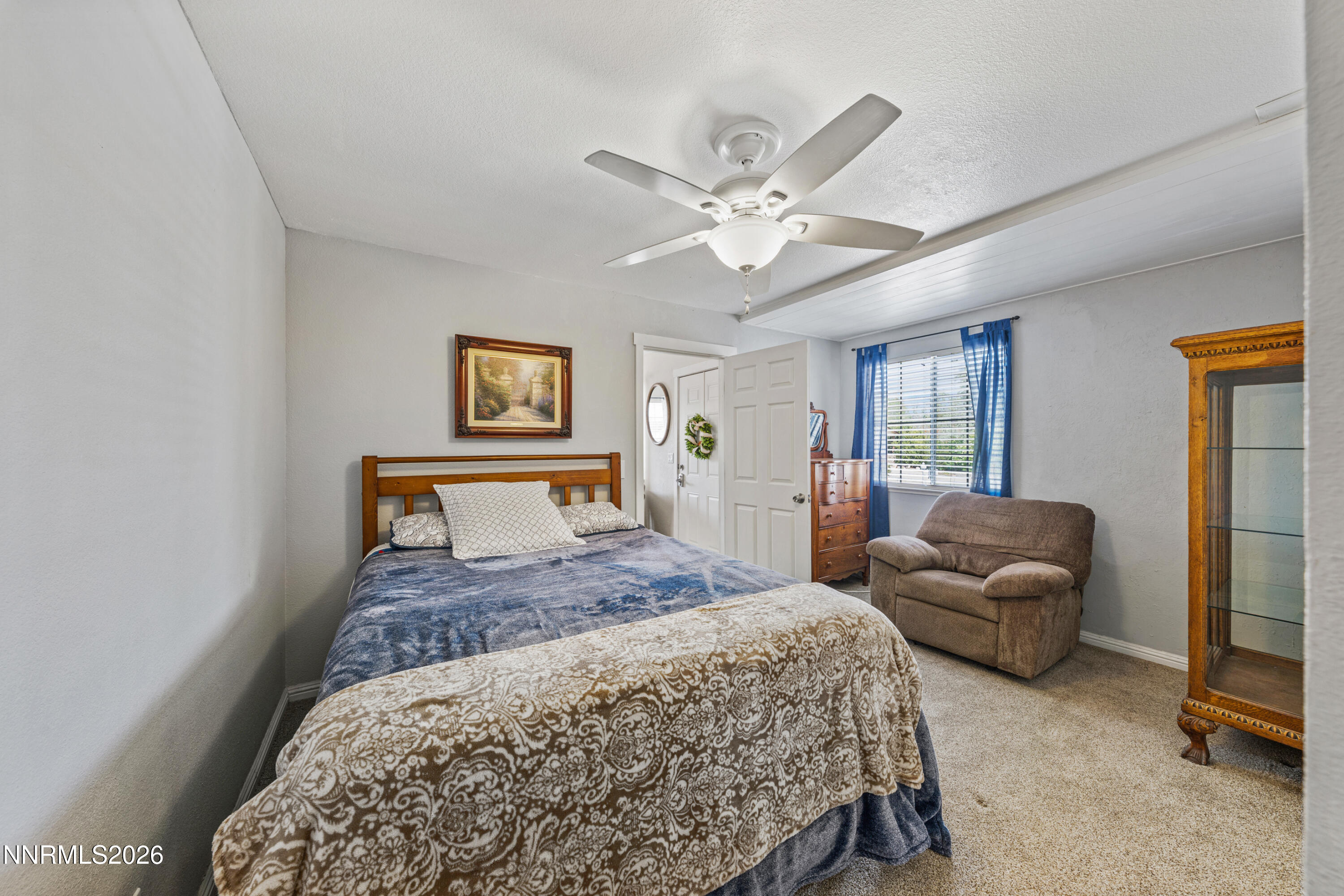 6370 Mono Court Sun Valley, NV 89433 - Photo 8 of 22 a bedroom with a bed and a chandelier