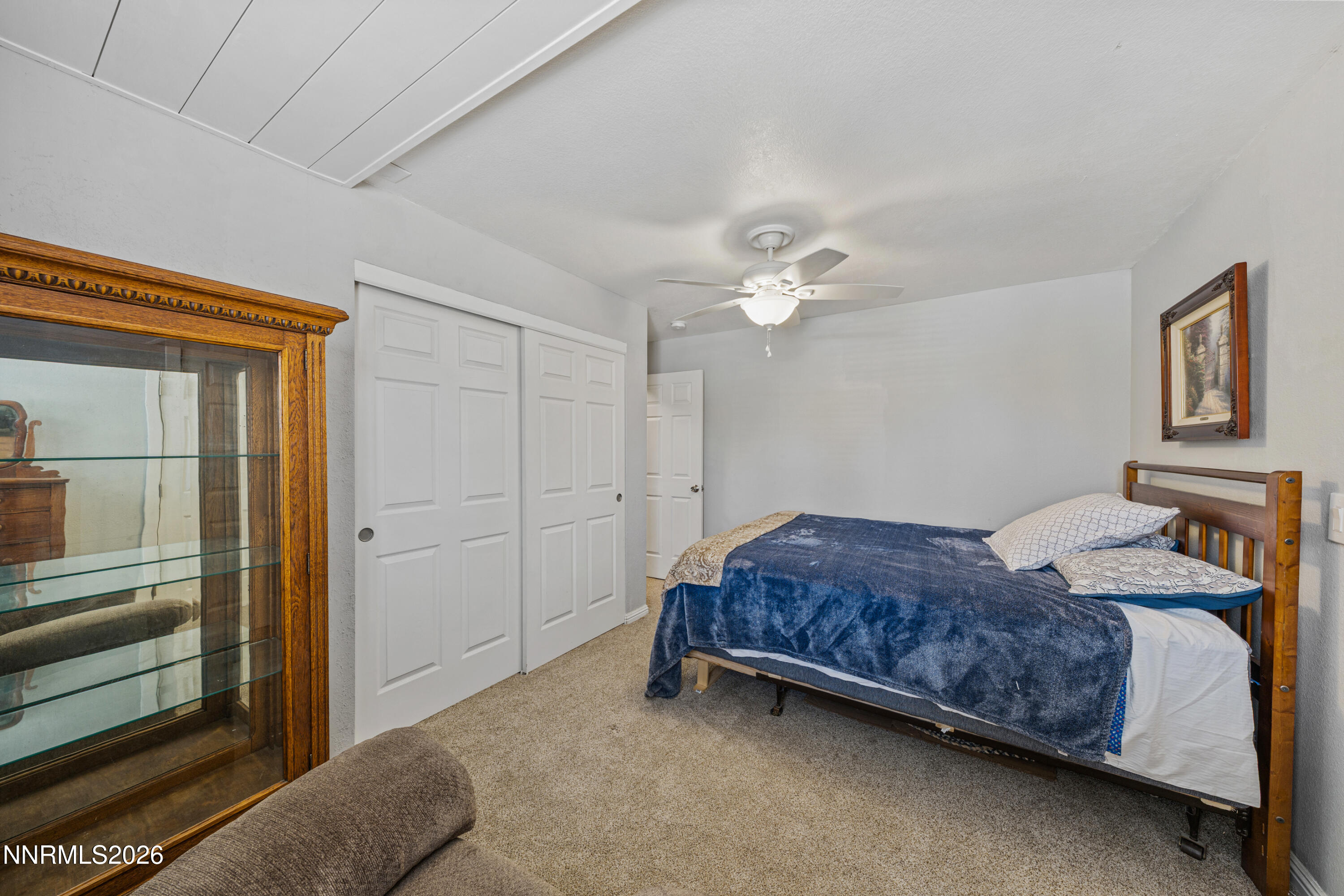 6370 Mono Court Sun Valley, NV 89433 - Photo 9 of 22 a spacious bedroom with a bed and lamp