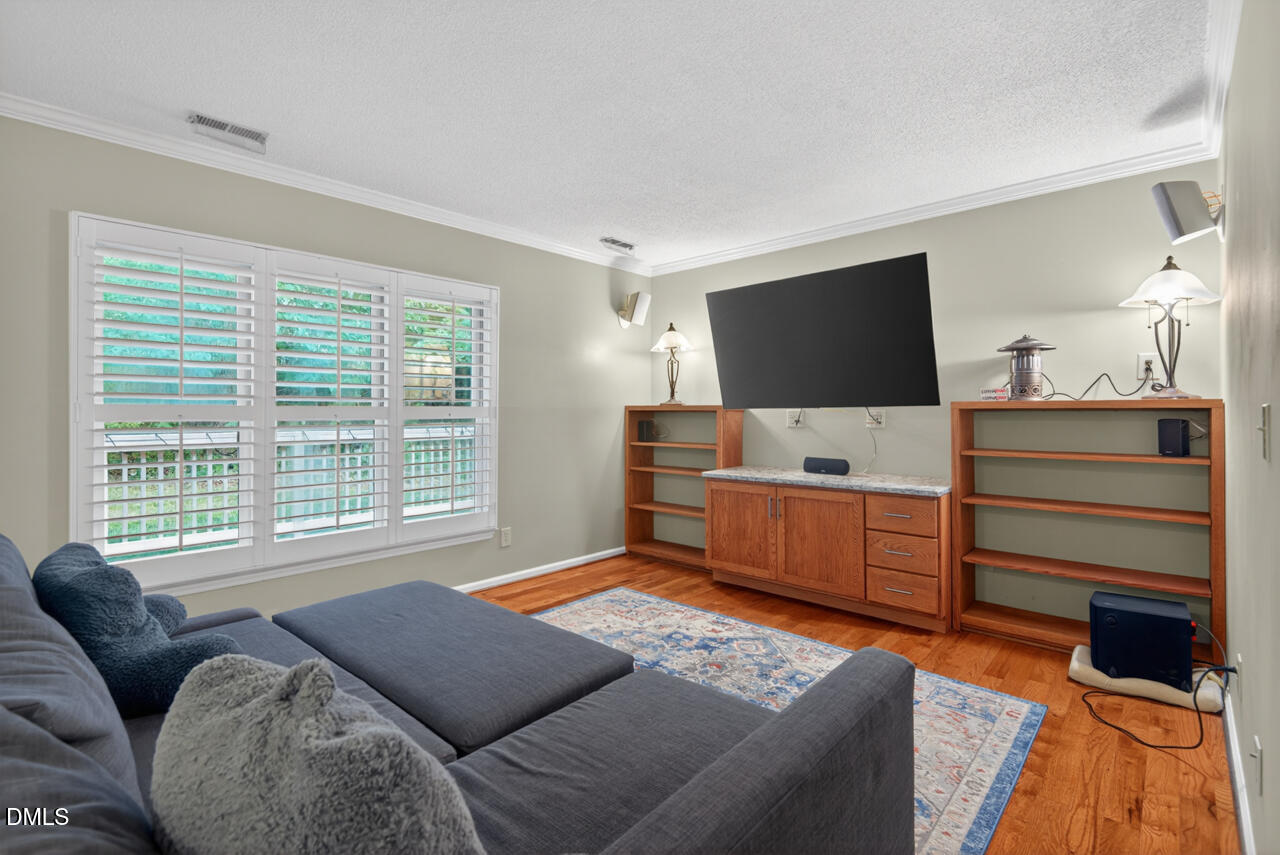 3307 Coachman's Way Durham, NC 27705 - Photo 20 of 50 a bedroom with furniture and flat screen tv