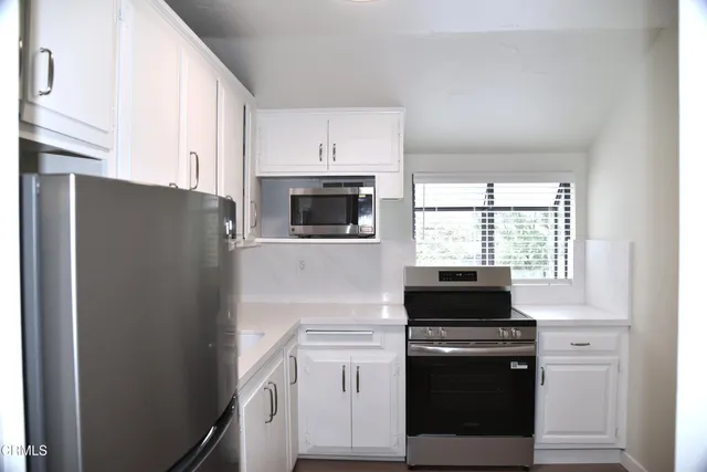 a kitchen with a refrigerator stove and microwave