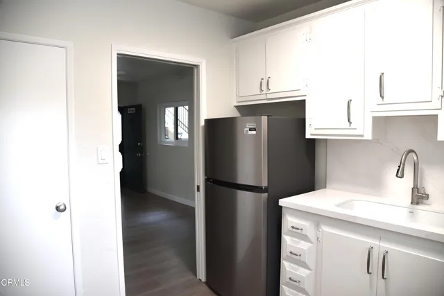 a kitchen with a refrigerator and a sink