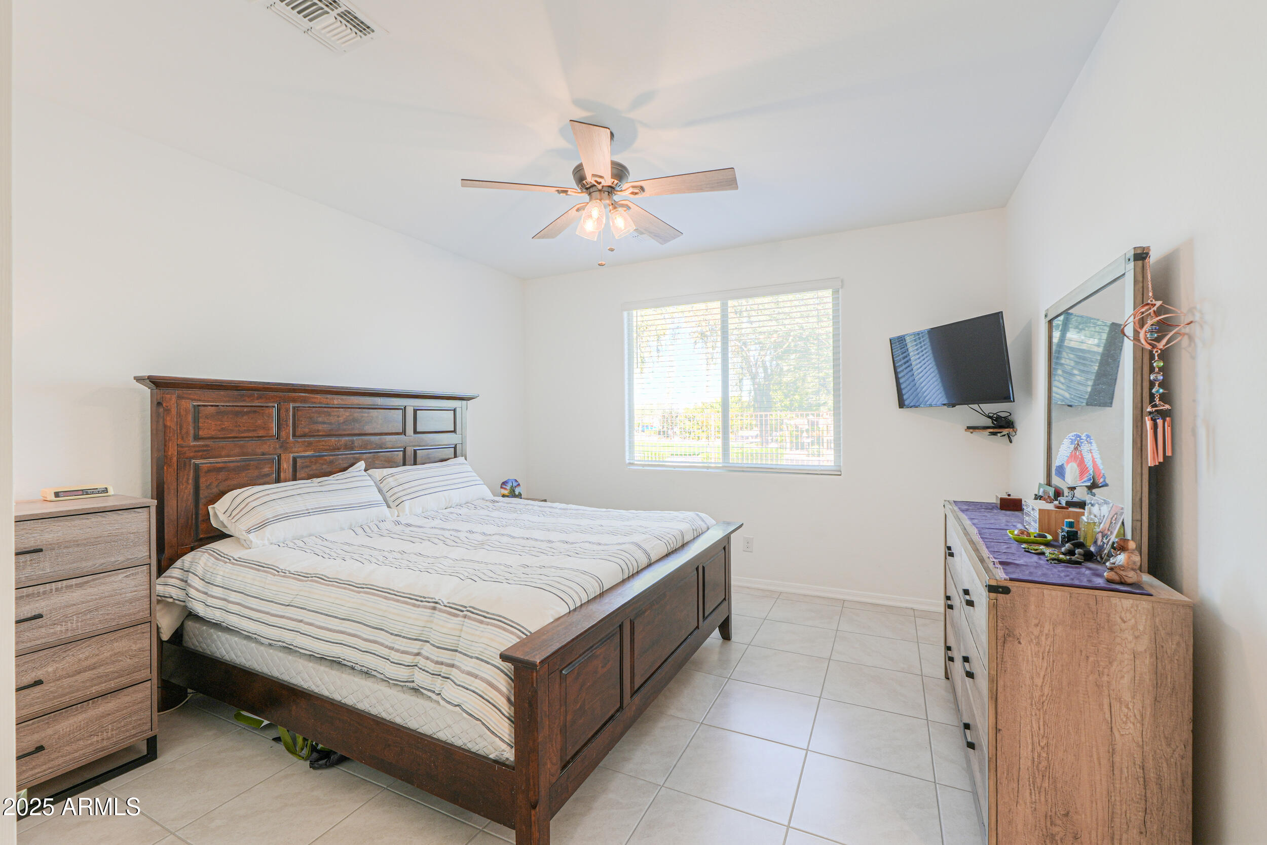44202 West Palo Olmo Road Maricopa, AZ 85138 - Photo 14 of 32 a bedroom with a bed and a flat screen tv