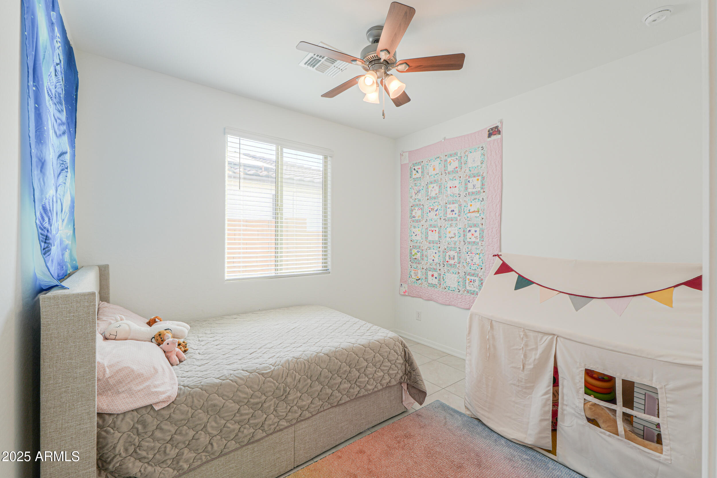 44202 West Palo Olmo Road Maricopa, AZ 85138 - Photo 18 of 32 a bedroom with a bed and a chandelier
