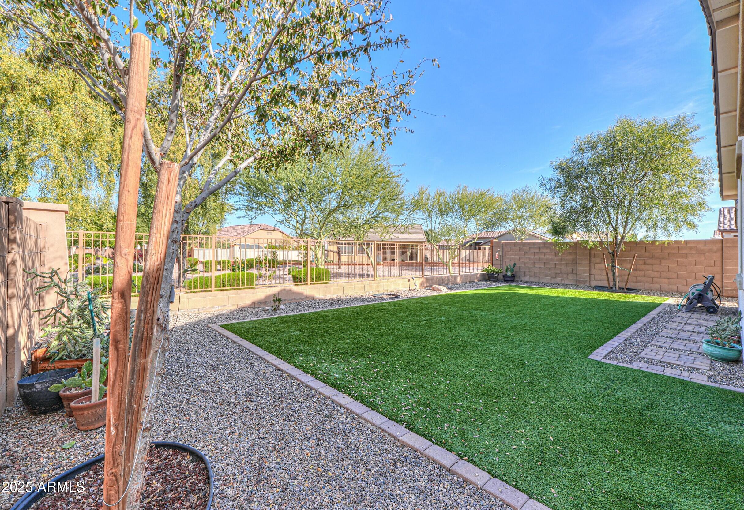 44202 West Palo Olmo Road Maricopa, AZ 85138 - Photo 25 of 32 a view of a backyard with large trees