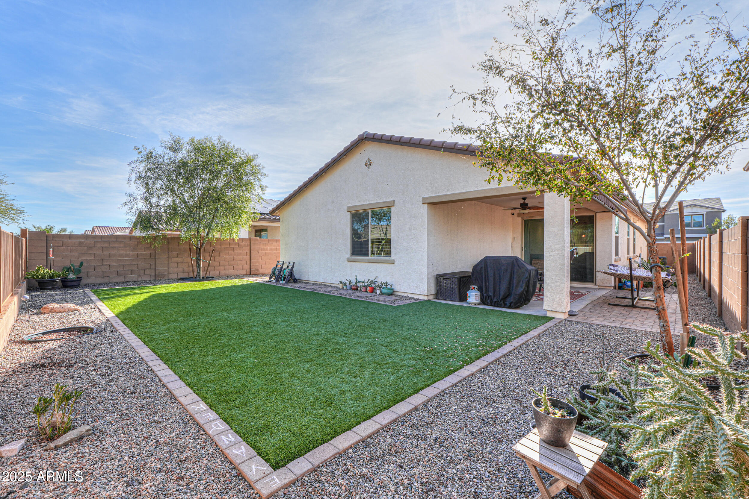 44202 West Palo Olmo Road Maricopa, AZ 85138 - Photo 27 of 32 a view of a backyard with plants and a large tree