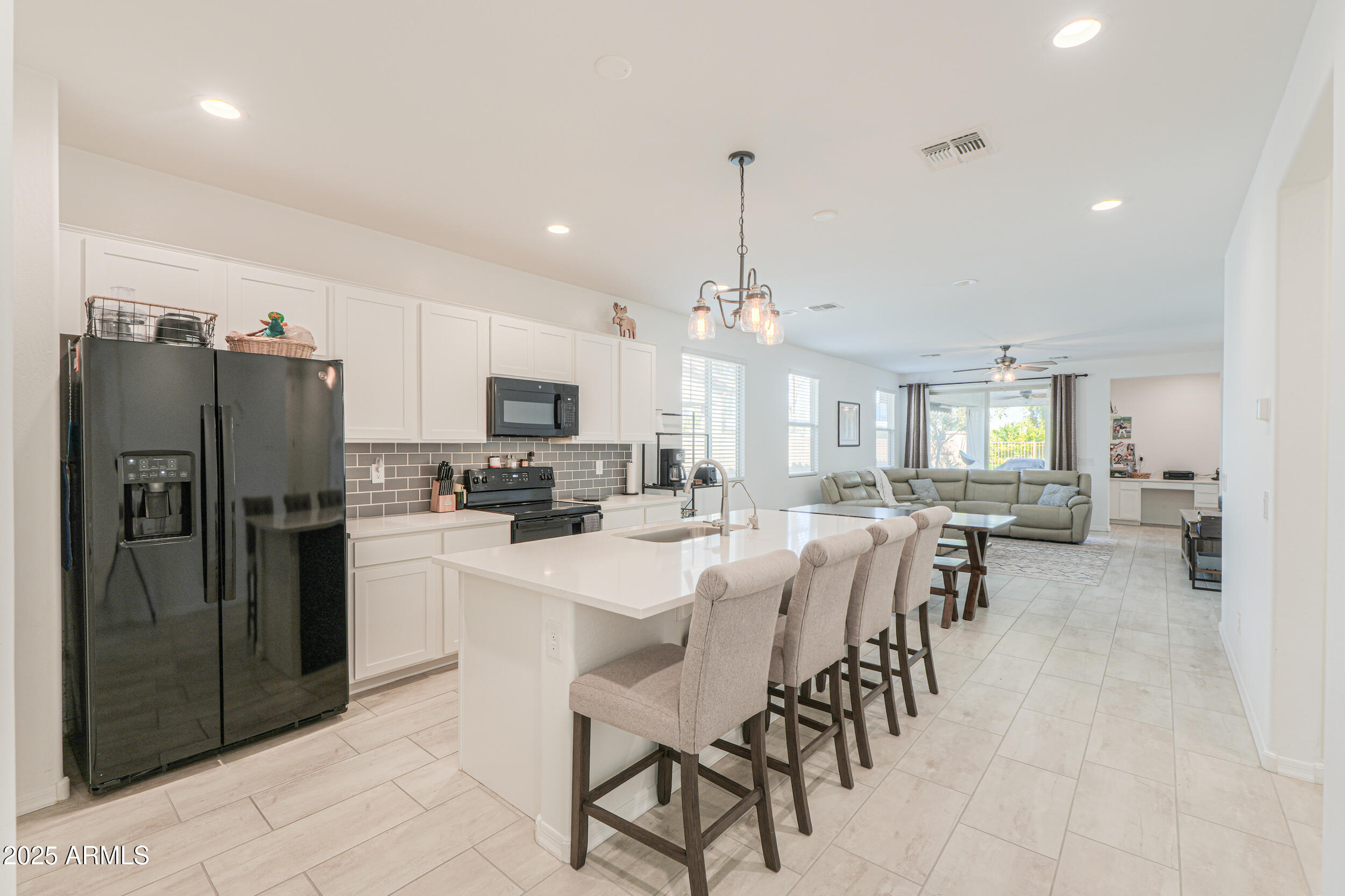 44202 West Palo Olmo Road Maricopa, AZ 85138 - Photo 4 of 32 a large kitchen with a table and chairs