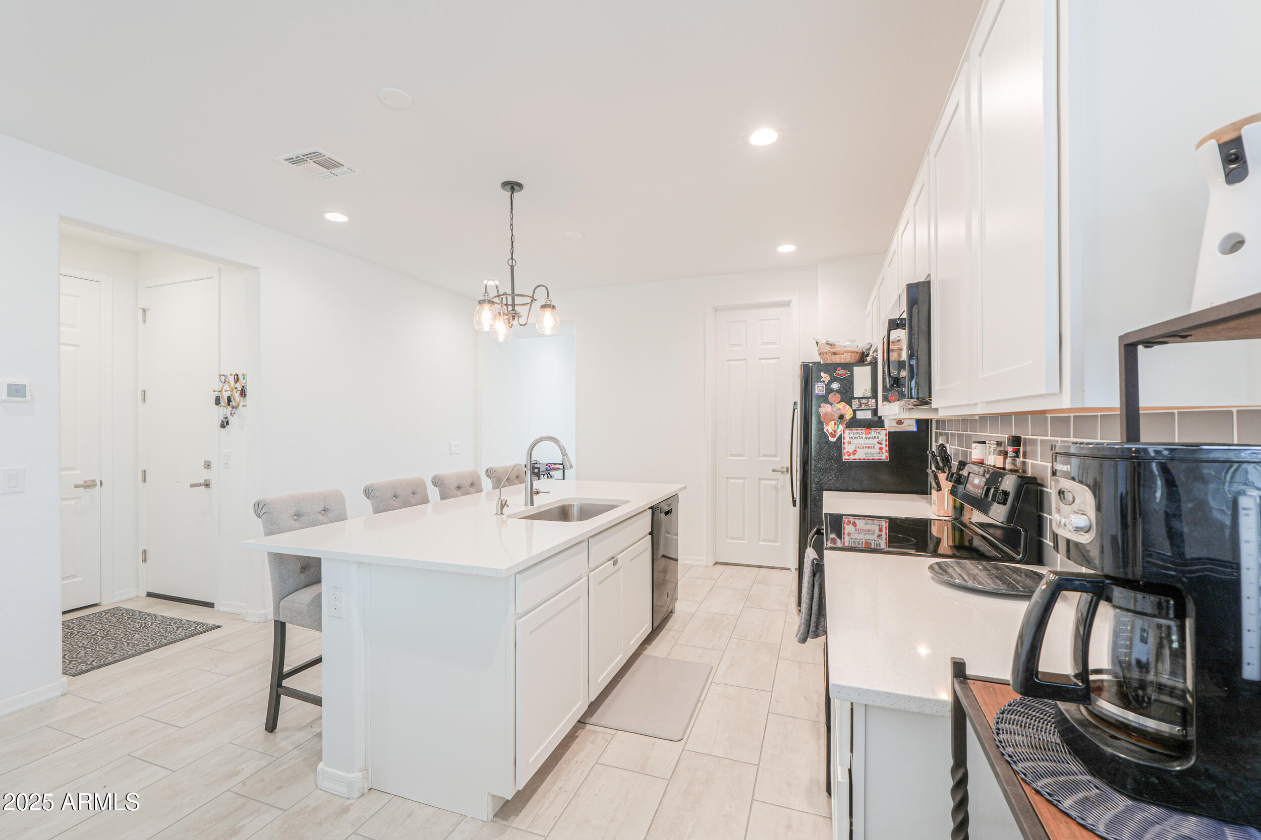 44202 West Palo Olmo Road Maricopa, AZ 85138 - Photo 6 of 32 a large white kitchen with a large window