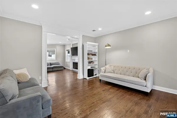 a living room with furniture and wooden floor