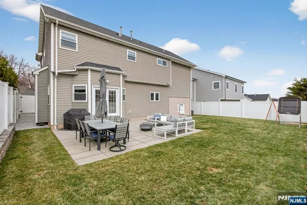 a backyard of a house with table and chairs