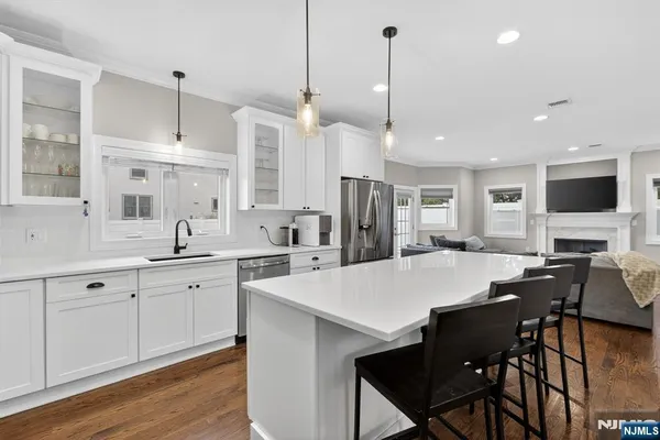 a large kitchen with a table and chairs