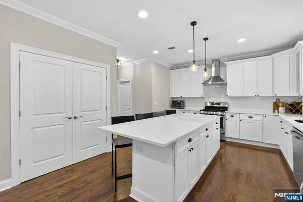 a large white kitchen with cabinets