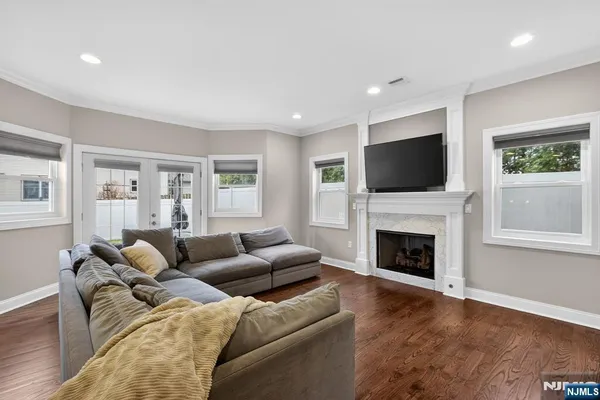a living room with furniture a fireplace and a flat screen tv