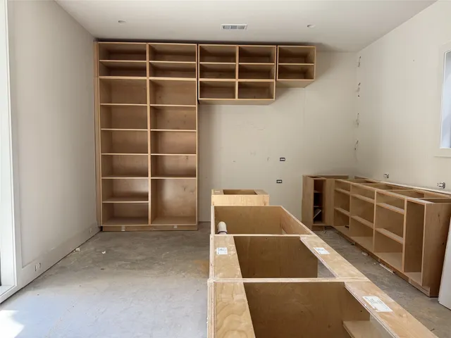 a view of walk in closet with empty racks