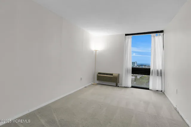 a view of an empty room with a cabinet